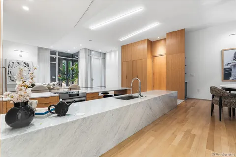 a kitchen with stainless steel appliances kitchen island granite countertop a sink and cabinets