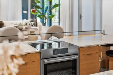 a picture of a living room with a mirror and a potted plant