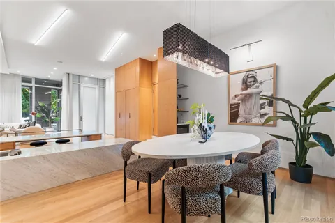 a dining room with furniture and wooden floor