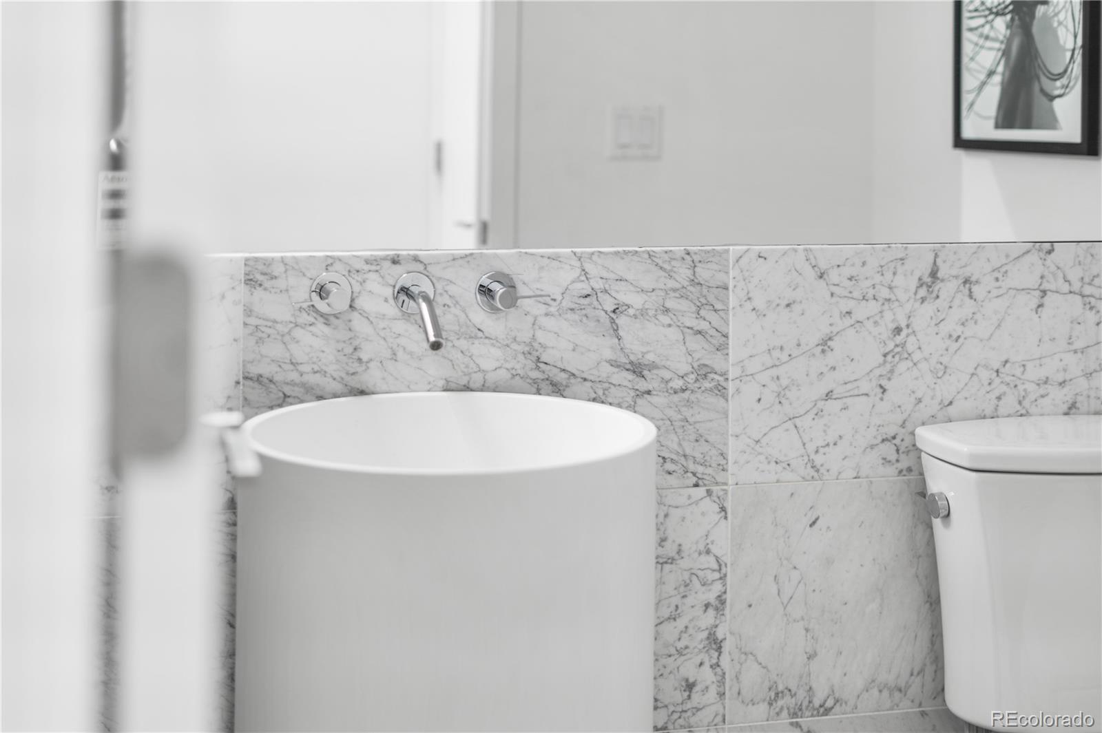 1115 West 37th Avenue Denver, CO 80211 - Photo 29 of 50 a bathroom with a sink and a toilet