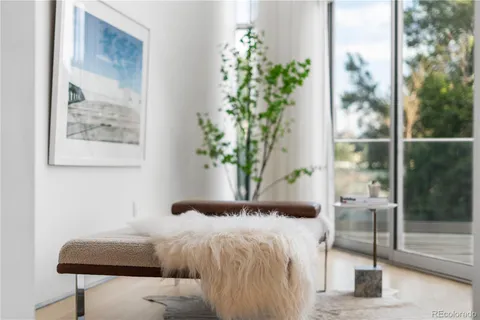 a living room with furniture and a floor to ceiling window