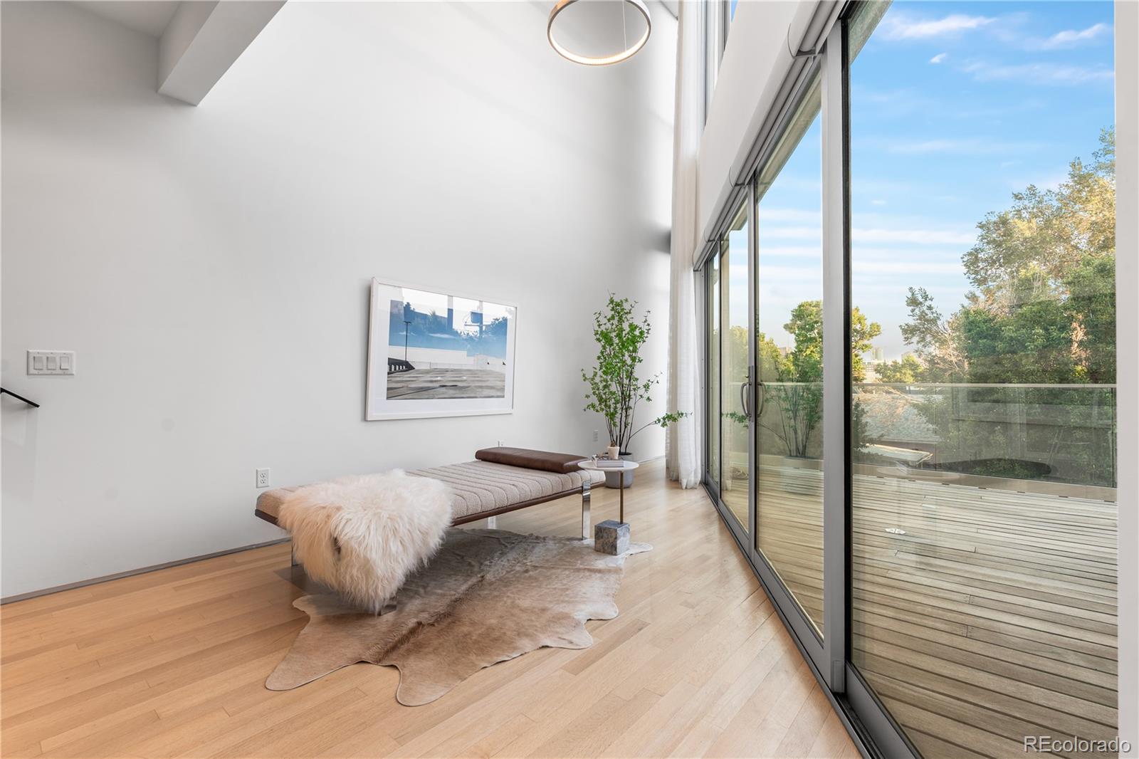 1115 West 37th Avenue Denver, CO 80211 - Photo 32 of 50 a living room with furniture and a floor to ceiling window