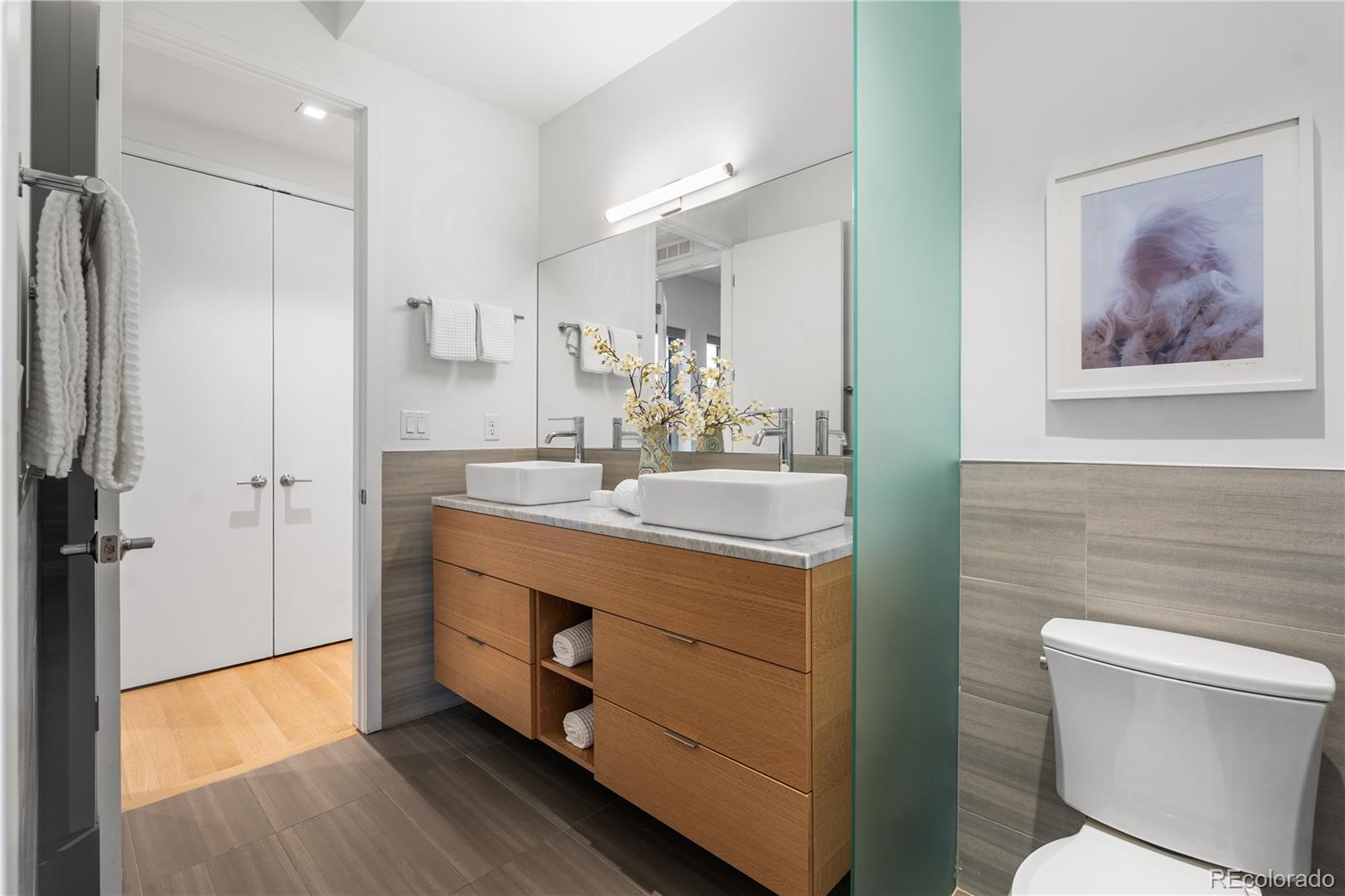 1115 West 37th Avenue Denver, CO 80211 - Photo 36 of 50 a bathroom with a granite countertop sink a toilet a shower and a mirror