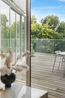 a outdoor space with lots of white furniture and a shower