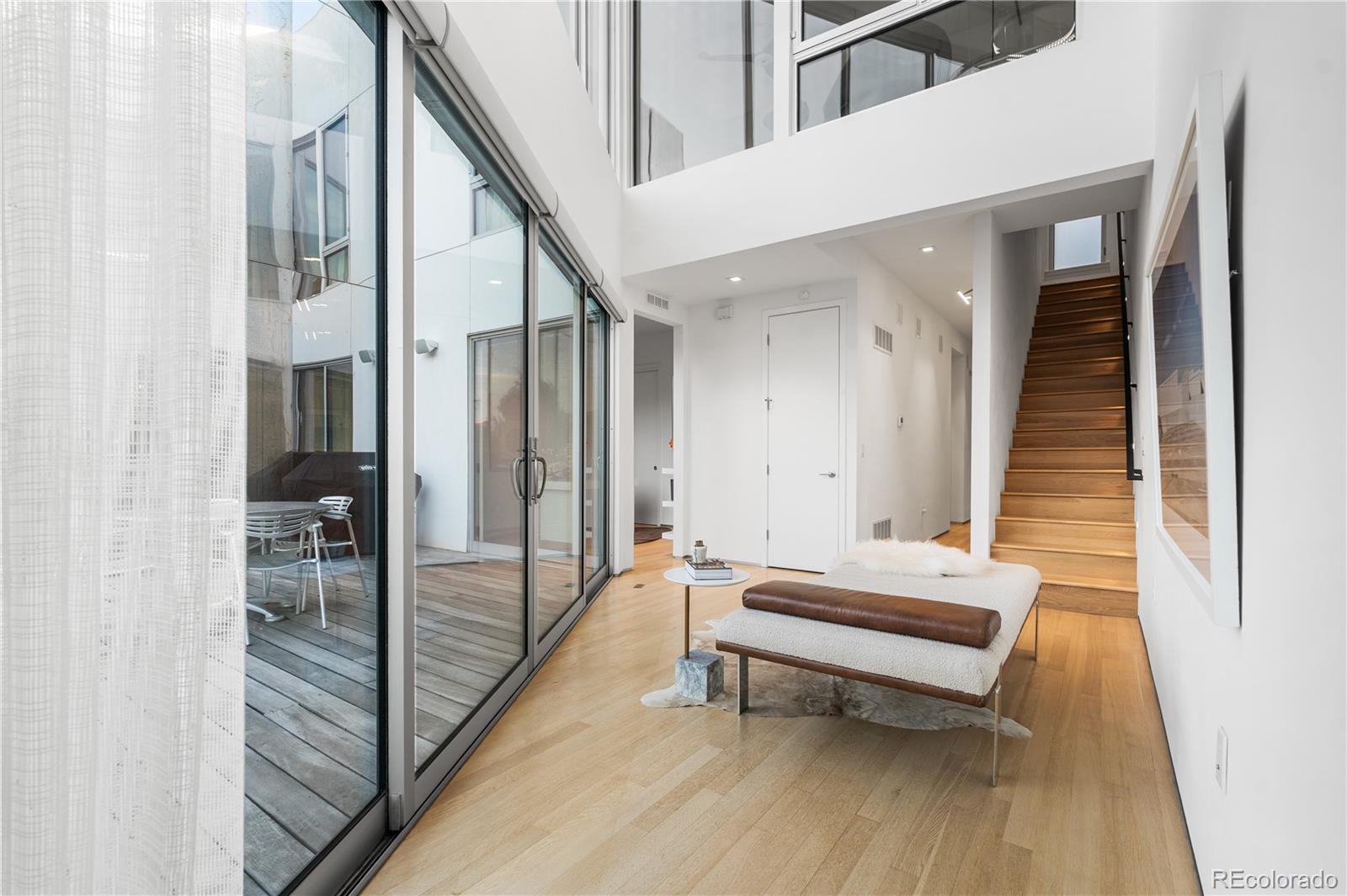 1115 West 37th Avenue Denver, CO 80211 - Photo 41 of 50 a hallway with stairs and wooden floor