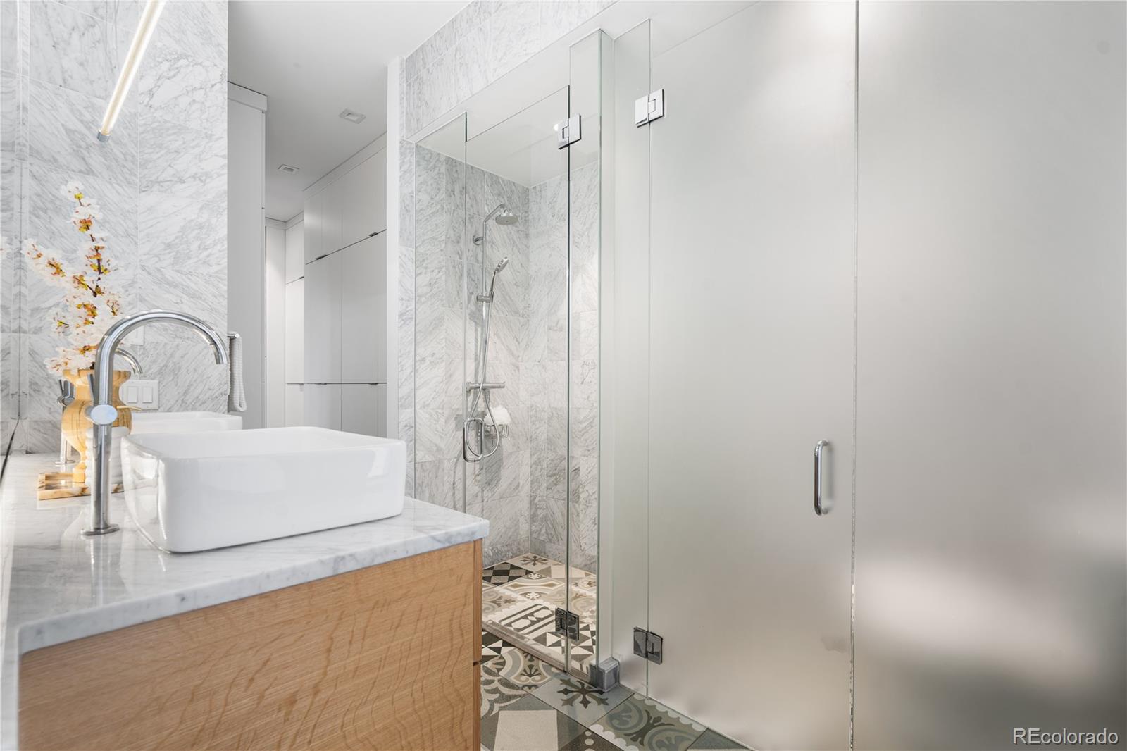 1115 West 37th Avenue Denver, CO 80211 - Photo 47 of 50 a bathroom with a granite countertop sink a mirror and shower