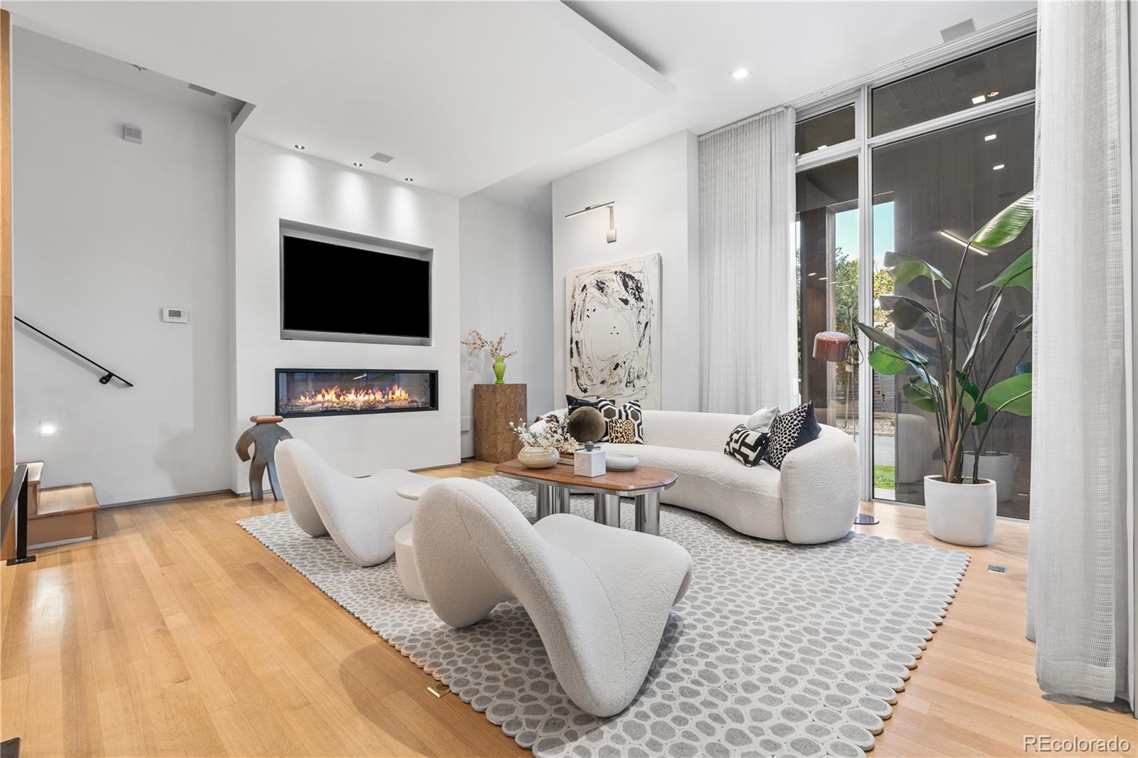 1115 West 37th Avenue Denver, CO 80211 - Photo 7 of 50 a living room with fireplace furniture and a flat screen tv