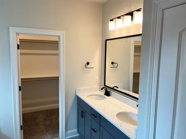a bathroom with a sink a mirror and a shower
