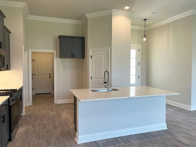 a spacious bathroom with a granite countertop sink mirror and shower