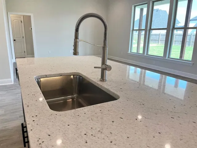 a kitchen with a sink and a mirror