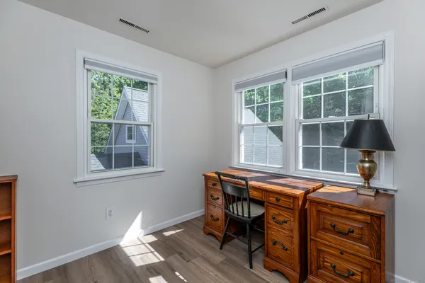 a table chair sitting in a room next to a window