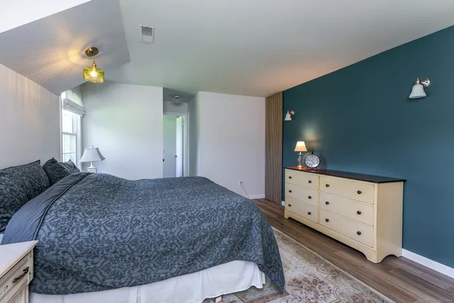 a bedroom with a bed and cabinets