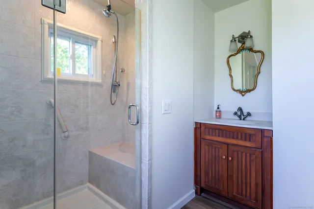 a bathroom with a sink a toilet and shower