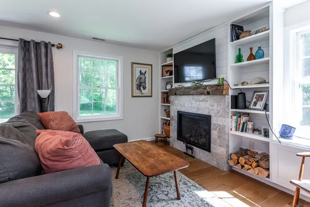 a living room with furniture fireplace and flat screen tv