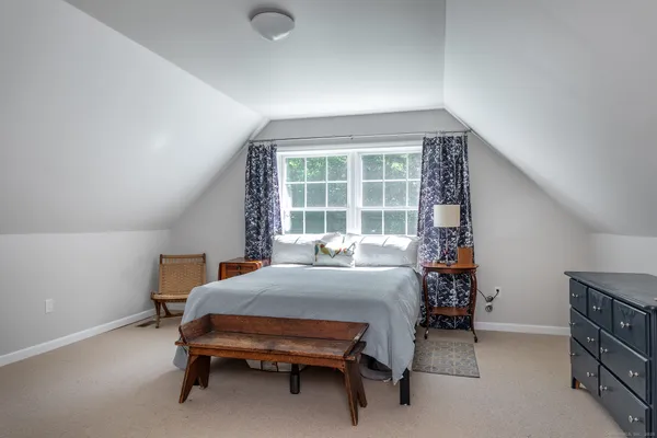 a bedroom with furniture and a window