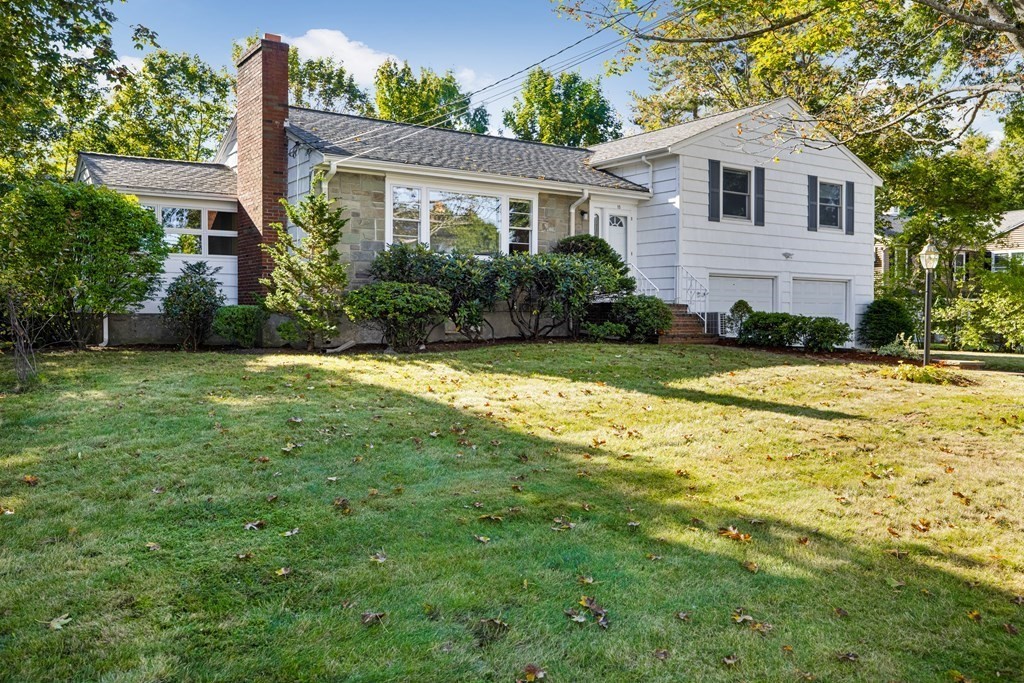 15 Hutchinson Road Lexington, MA 02421 - Photo 1 of 26 a front view of a house with a garden