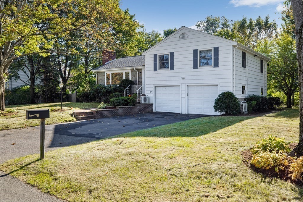 15 Hutchinson Road Lexington, MA 02421 - Photo 24 of 26 a front view of a house with a yard and garage
