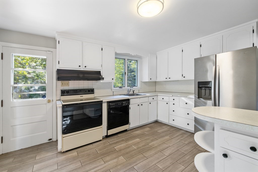 15 Hutchinson Road Lexington, MA 02421 - Photo 6 of 26 a kitchen with stainless steel appliances a stove a refrigerator and a window