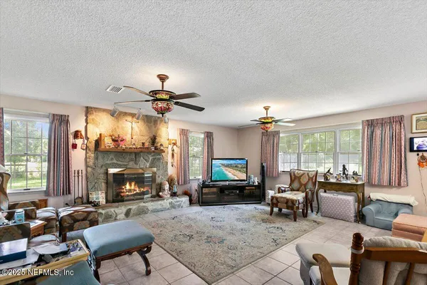 a view of a dining room with furniture a chandelier and wooden floor