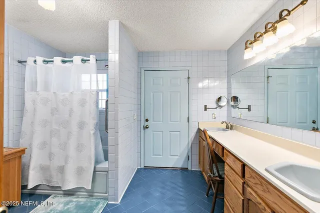 a bathroom with a sink a mirror and a shower