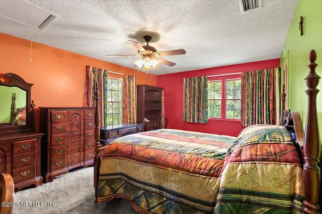 a bedroom with a bed dresser and a window