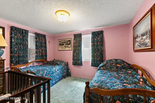 a view of a big room with a fireplace and windows in a yard