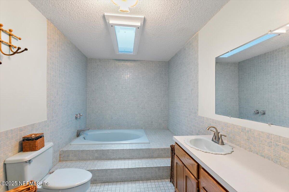 2634 Joe Ashton Road St. Augustine, FL 32092 - Photo 30 of 49 a bathroom with a sink toilet and bathtub