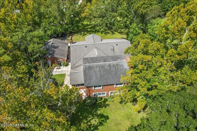 an aerial view of a house with a yard and garden