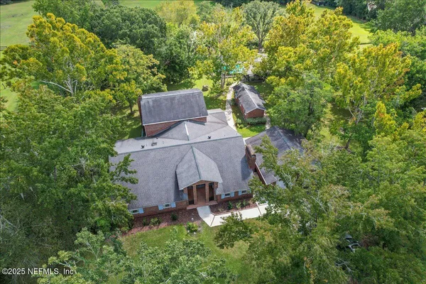 an aerial view of a house with a yard and garden