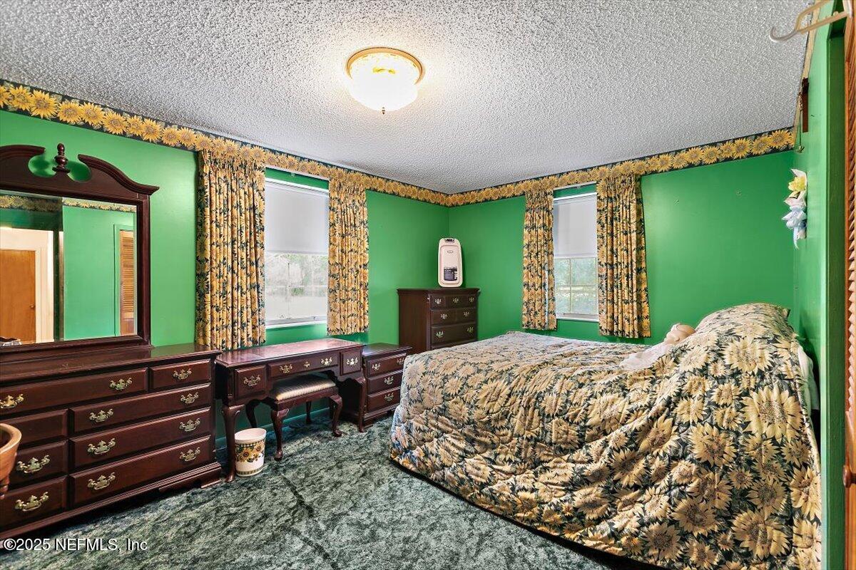 2634 Joe Ashton Road St. Augustine, FL 32092 - Photo 32 of 49 a bed room with a bed mirror and a window