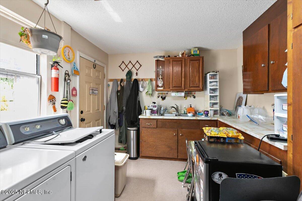 2634 Joe Ashton Road St. Augustine, FL 32092 - Photo 39 of 49 a kitchen with a sink stove and refrigerator