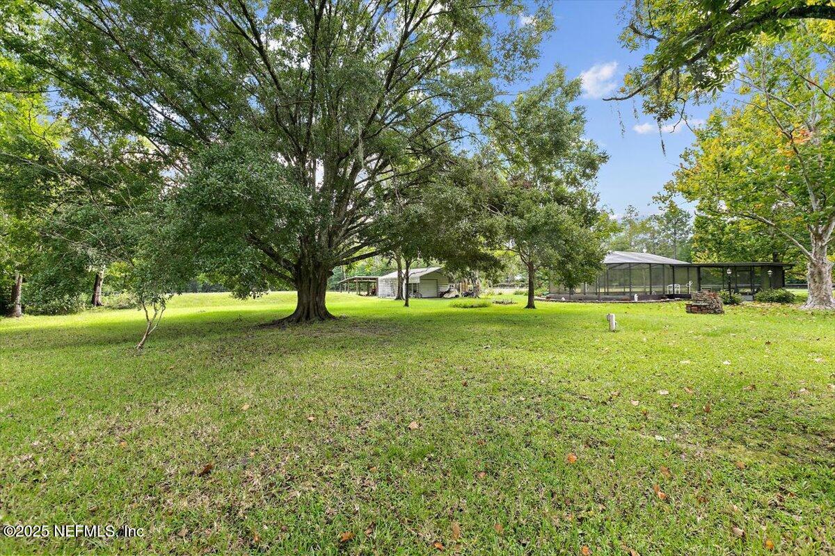 2634 Joe Ashton Road St. Augustine, FL 32092 - Photo 45 of 49 a view of grassy field with benches and trees all around