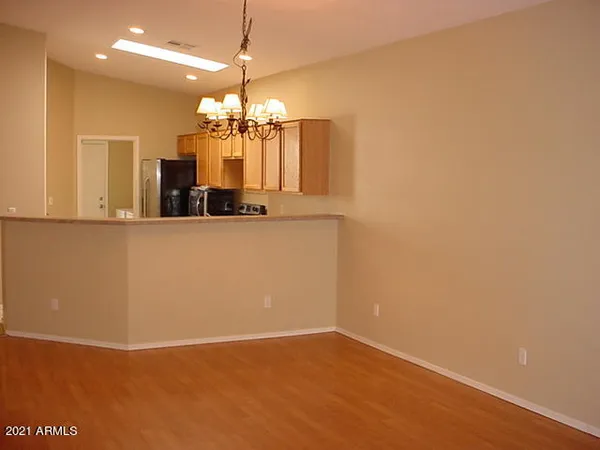 a view of a kitchen with a sink and chandelier