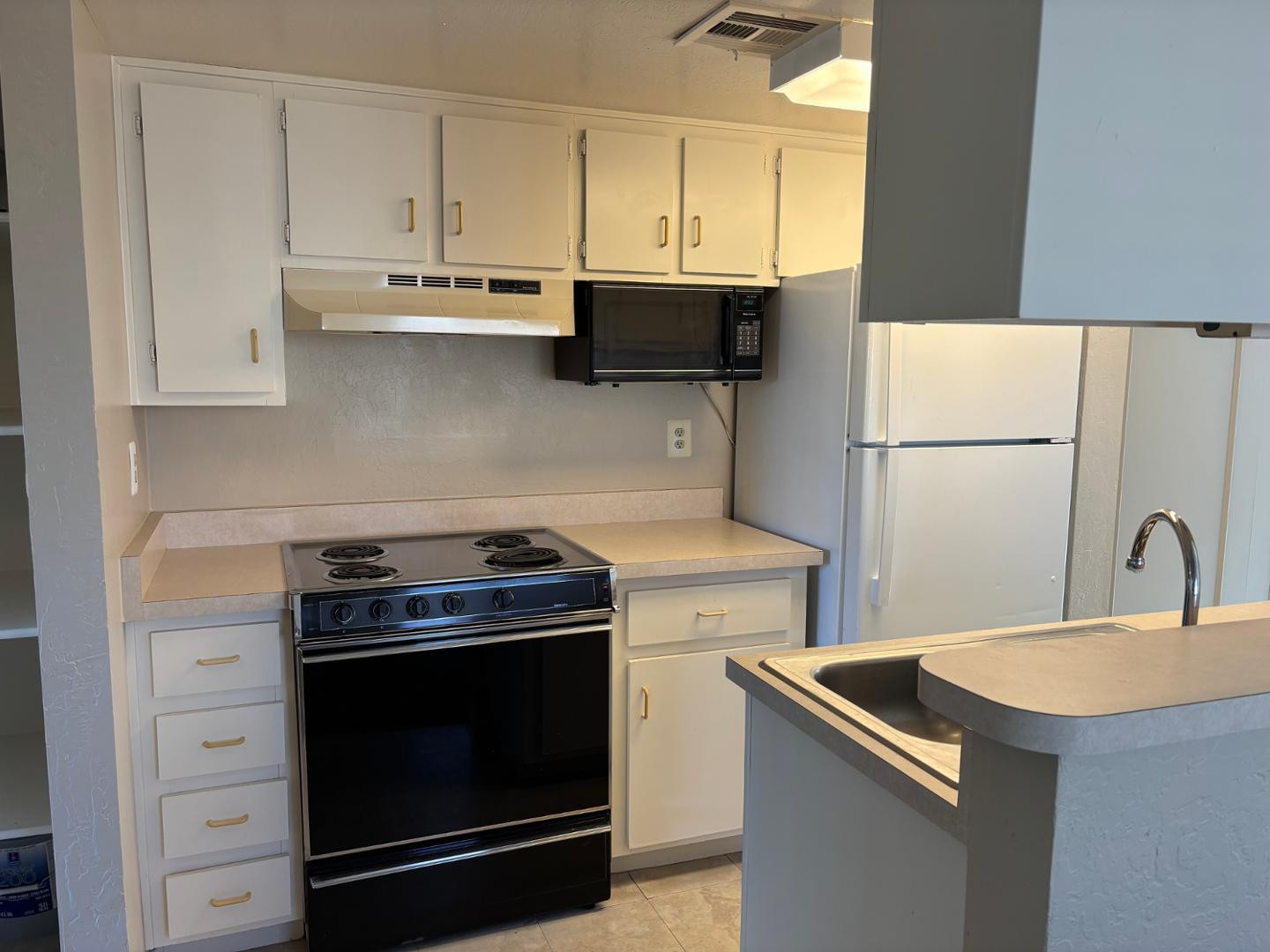12123 West Bell Road, Unit 225 Surprise, AZ 85378 - Photo 5 of 12 a kitchen with a stove sink and refrigerator