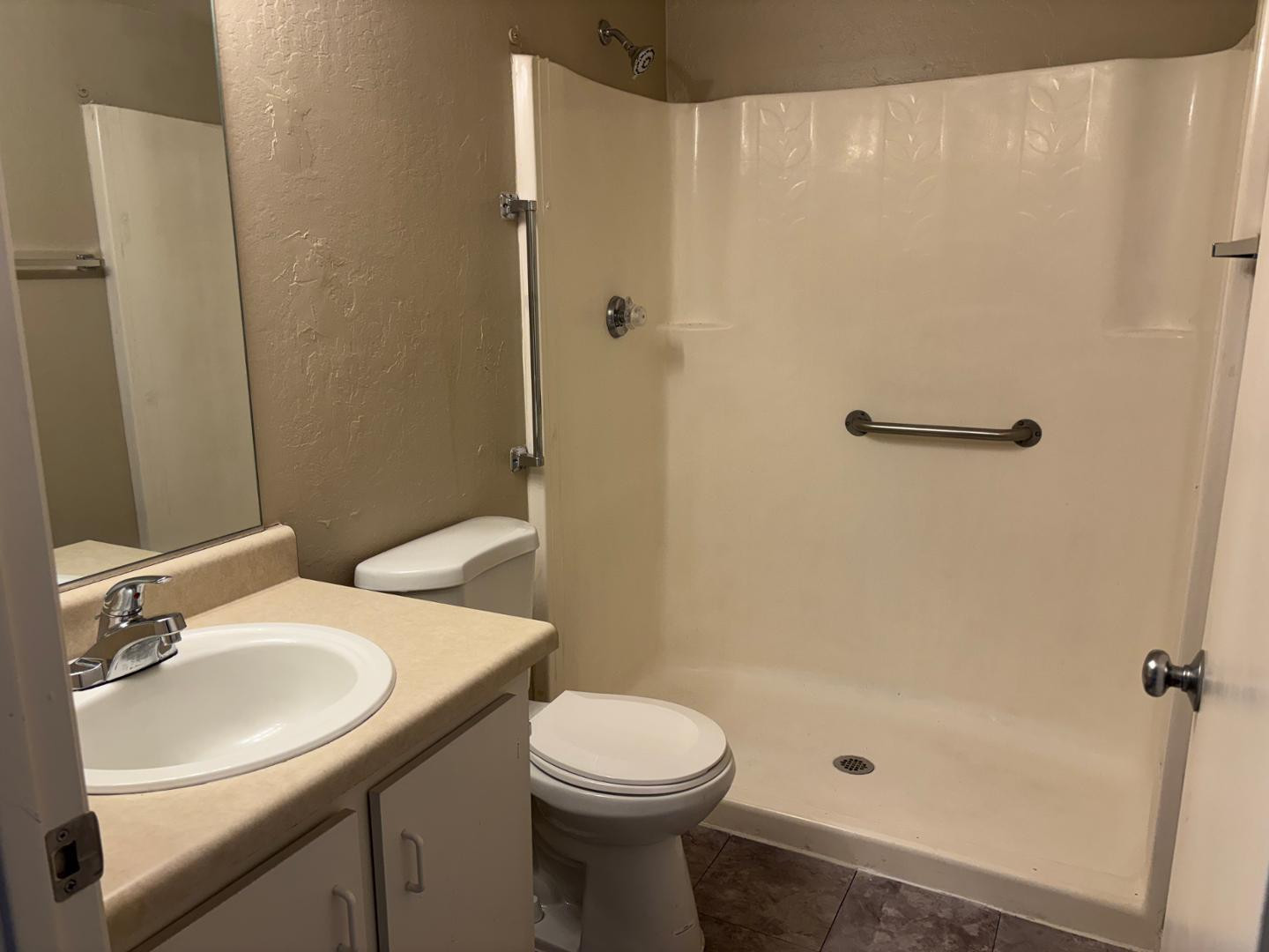 12123 West Bell Road, Unit 225 Surprise, AZ 85378 - Photo 9 of 12 a bathroom with a sink a toilet and shower
