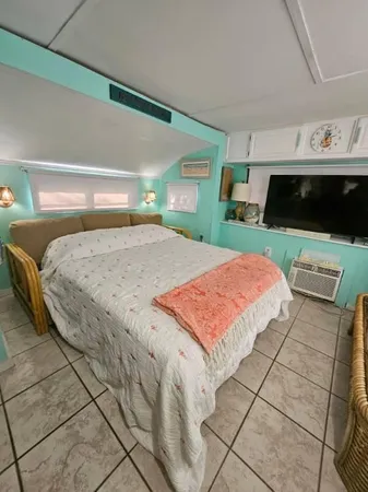 a view of a patio with table and chairs with wooden floor and fence