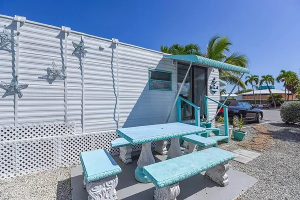 a view of a chairs and table in backyard