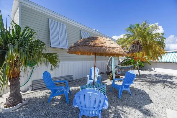 a view of backyard with outdoor seating and wooden fence