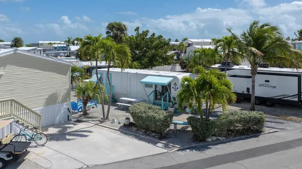 an aerial view of a house with a garden and lake view