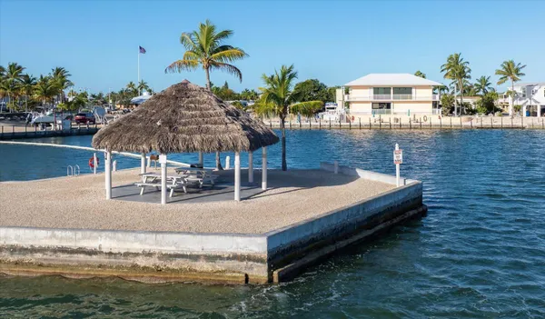a view of a swimming pool and a dining table chairs