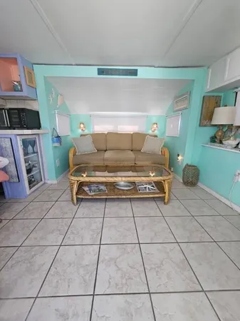 a living room with a couch and a stove top oven
