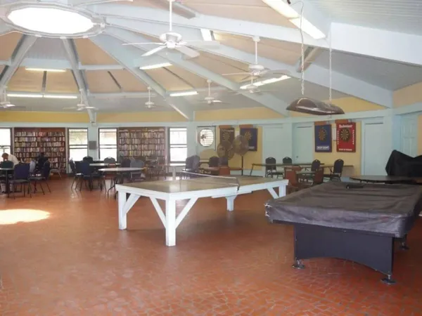 a view of a patio with a table and chairs under an umbrella