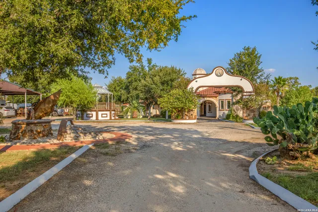 a view of a street with a bench and trees