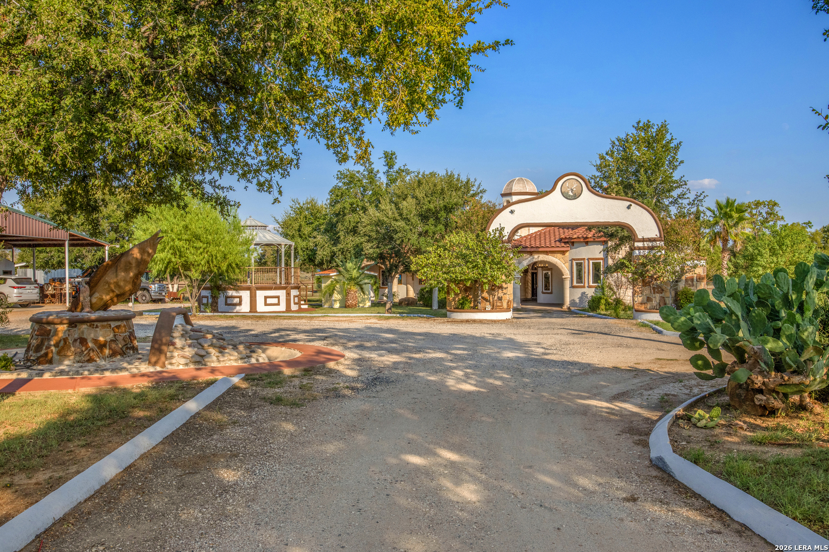 a view of a street with a bench and trees