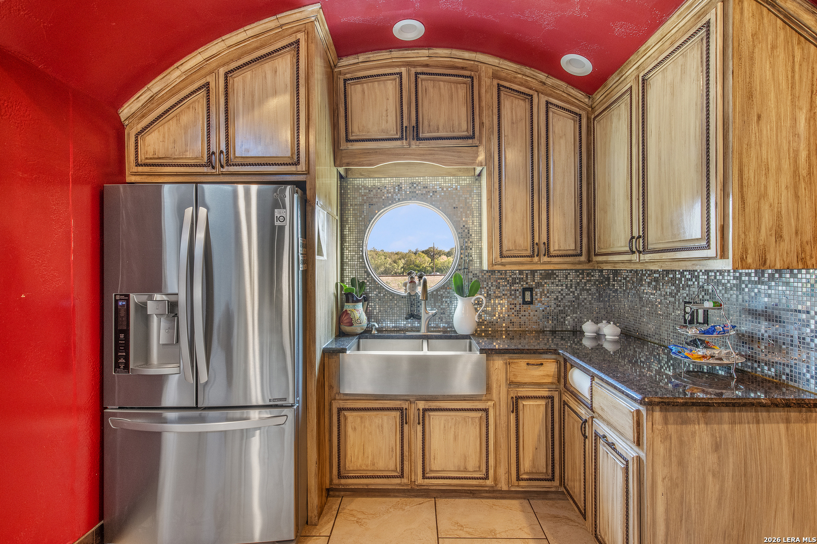 13196 Kelly Road Atascosa, TX 78002 - Photo 14 of 25 a kitchen with stainless steel appliances granite countertop a refrigerator sink and cabinets