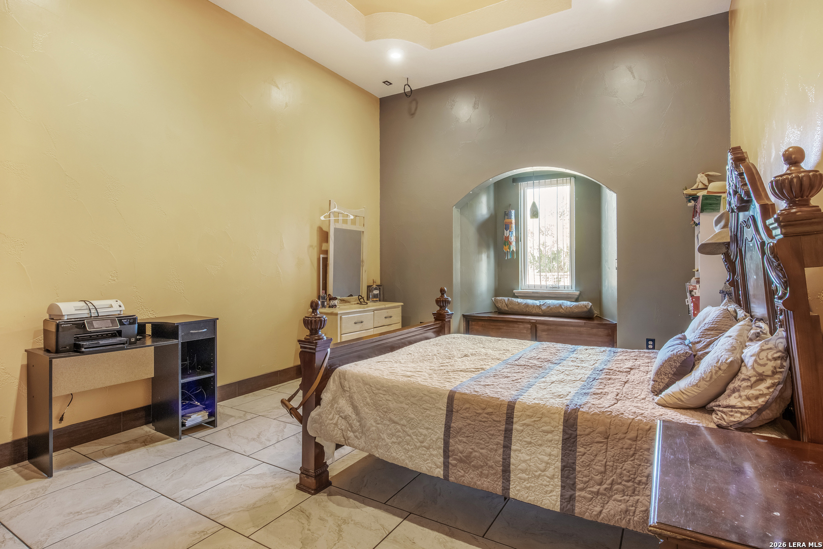 13196 Kelly Road Atascosa, TX 78002 - Photo 20 of 25 a bedroom with a bed and a chandelier