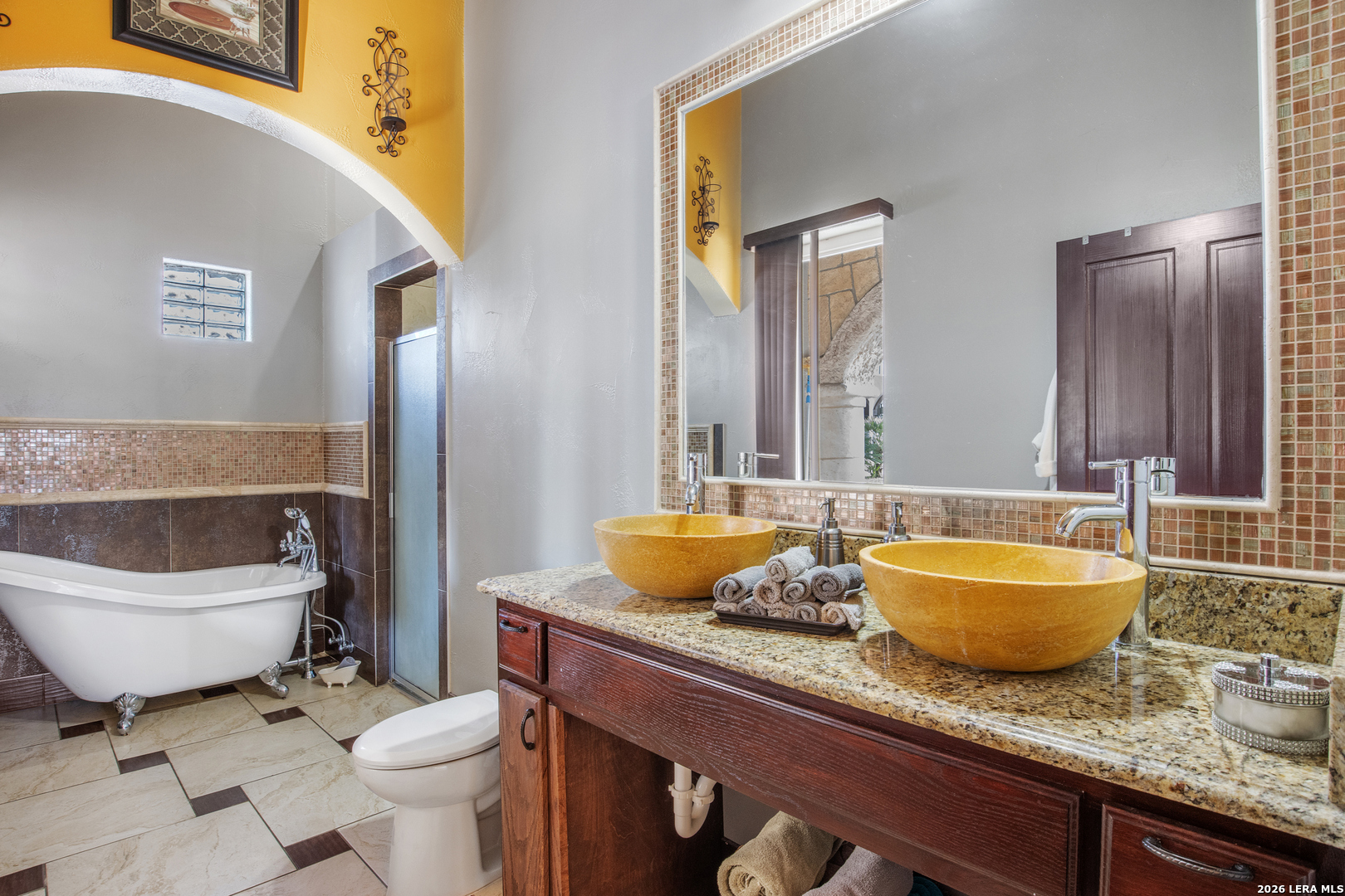 13196 Kelly Road Atascosa, TX 78002 - Photo 22 of 25 a bathroom with a granite countertop toilet sink and mirror