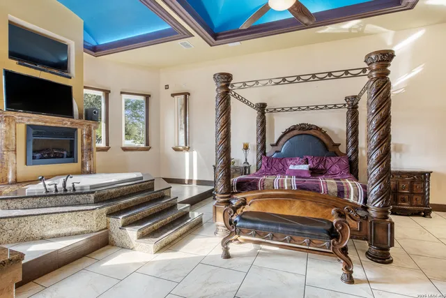 a living room with fireplace furniture and a flat screen tv