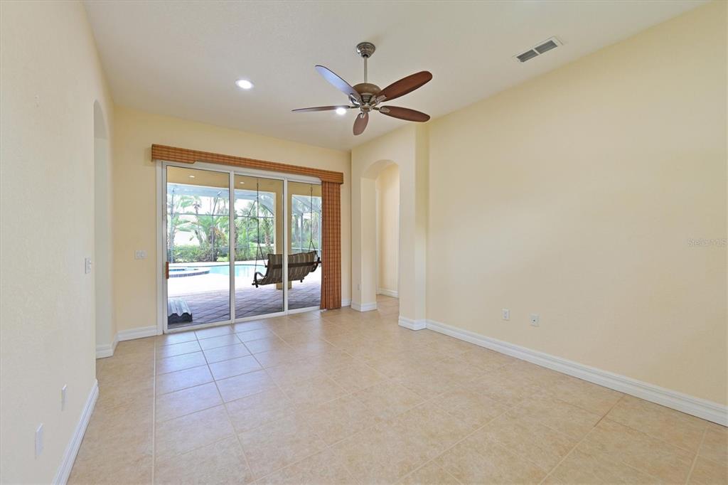 10622 Conch Shell Terrace Bradenton, FL 34212 - Photo 32 of 69 a view of a livingroom with a ceiling fan and window