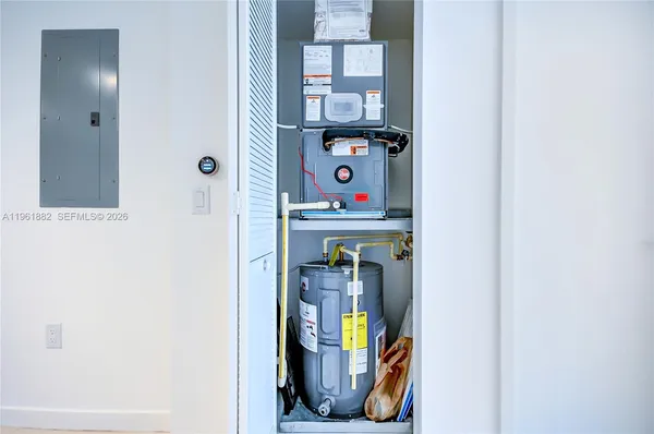 a view of walk in closet with clothes